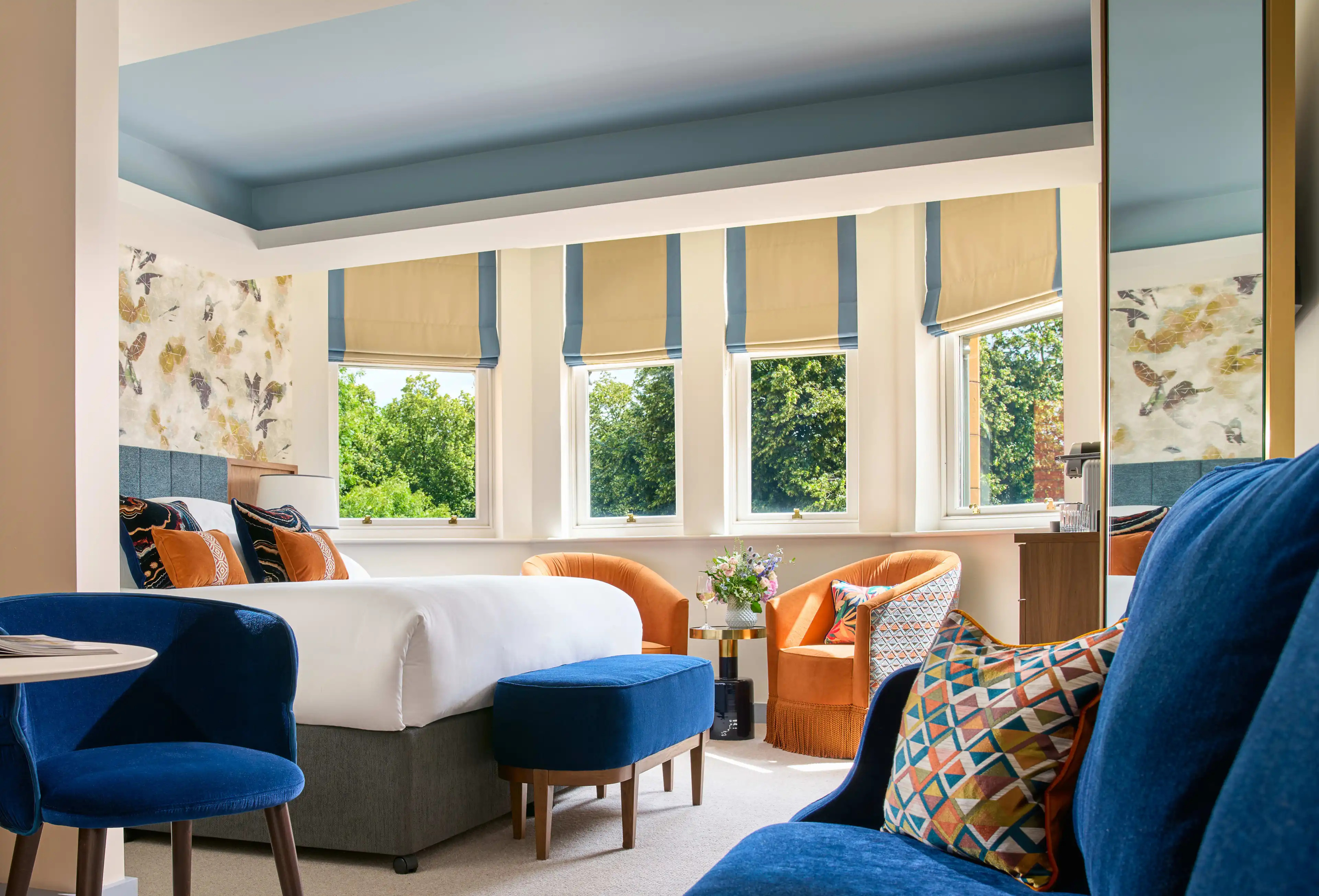 Vibrant hotel room with royal blue and orange chairs, contemporary Irish design
